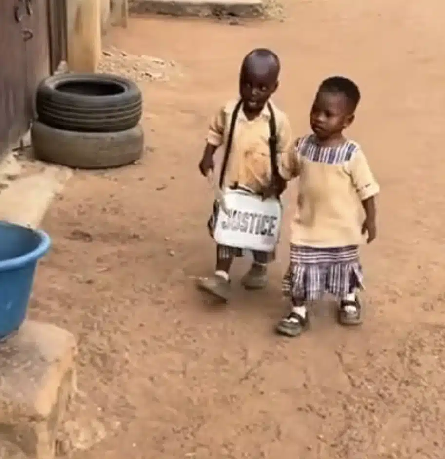 Adorable moment schoolboy escorts his female classmate home 
