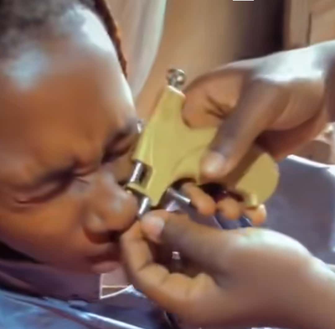 "Jesus, holy ghost, God of Zechariah help me" - Nigerian lady's dramatic reaction during nose piercing causes stir online