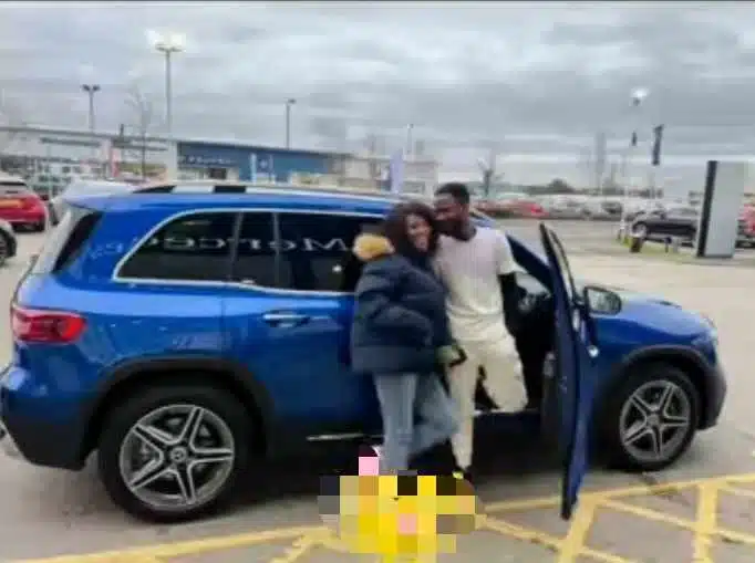 “Na man wey submissive we go buy car for” — Reactions as UK based Nigerian nurse surprise husband with brand new Benz 