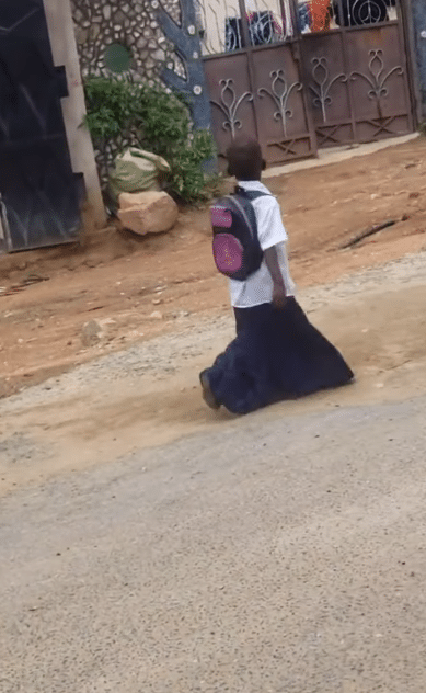 "She will wear it till SS3" - Video of primary school girl walking on the road in overflowing uniform causes buzz online