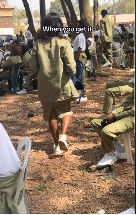 "She still wear hair wey no be her own" - Backlash as corper is seen putting on skirt at NYSC function