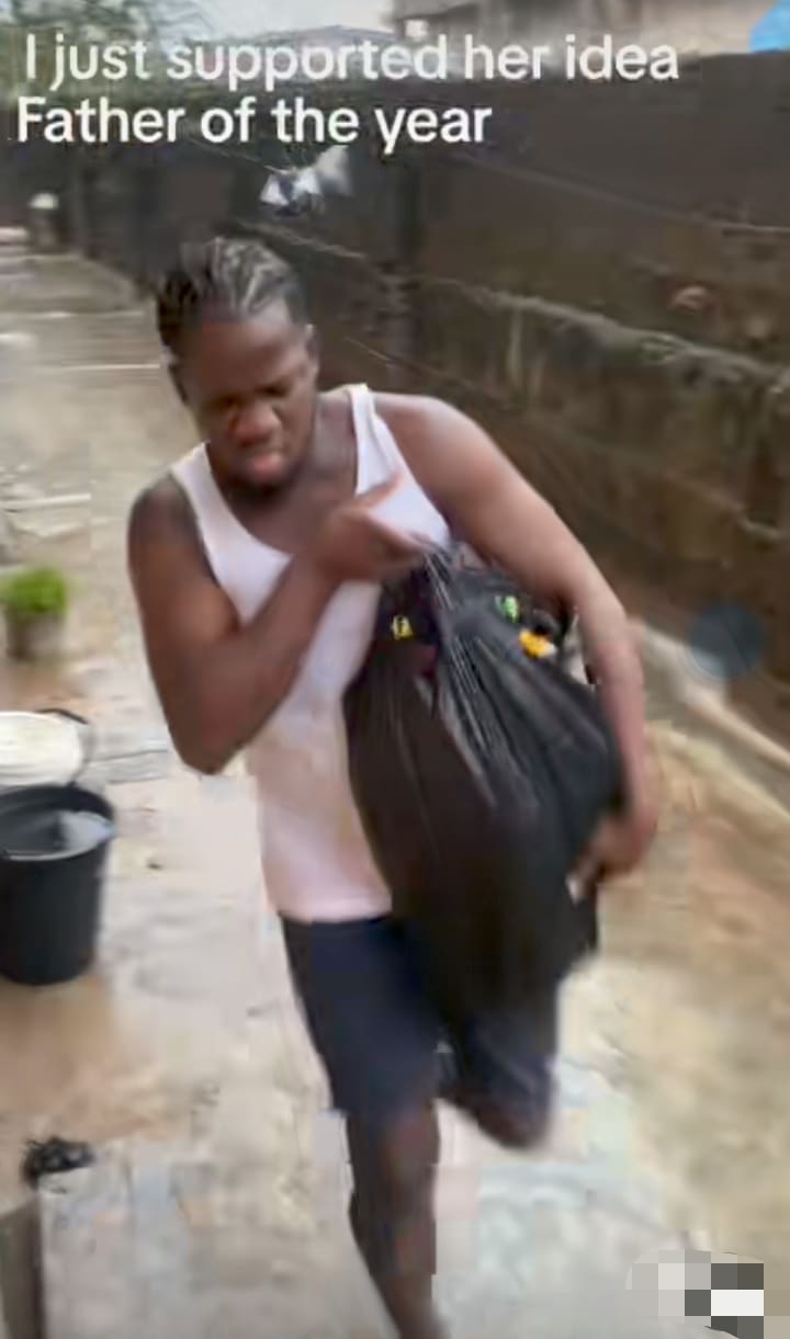 "You for explain tire if police catch you" – Man carries little daughter in nylon bag to protect her from rain 