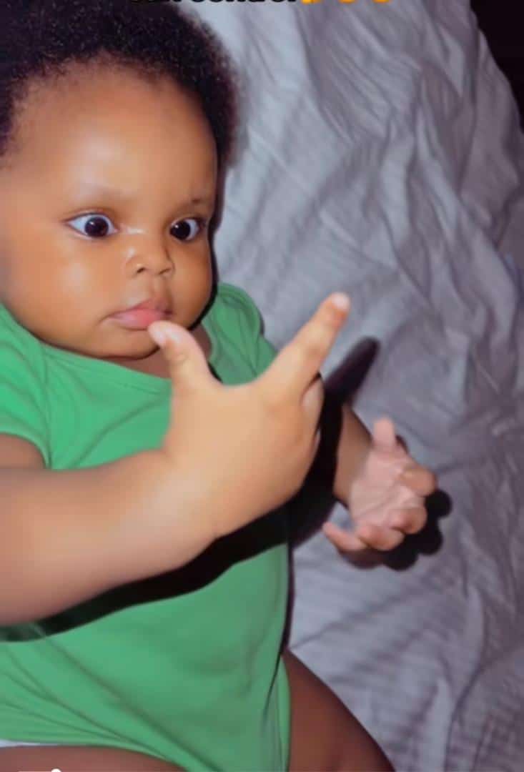 Adorable moment baby discovers she is born with hands and legs