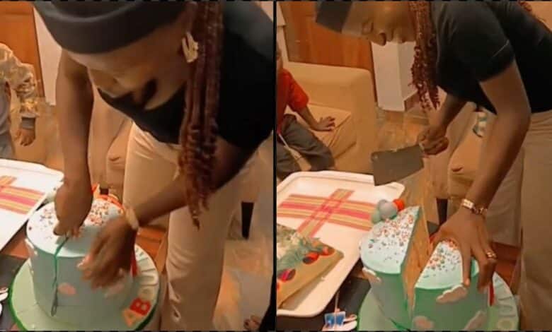 "Na Dangote cement dem use bake am?" - Speculations as mother struggles to cut birthday cake