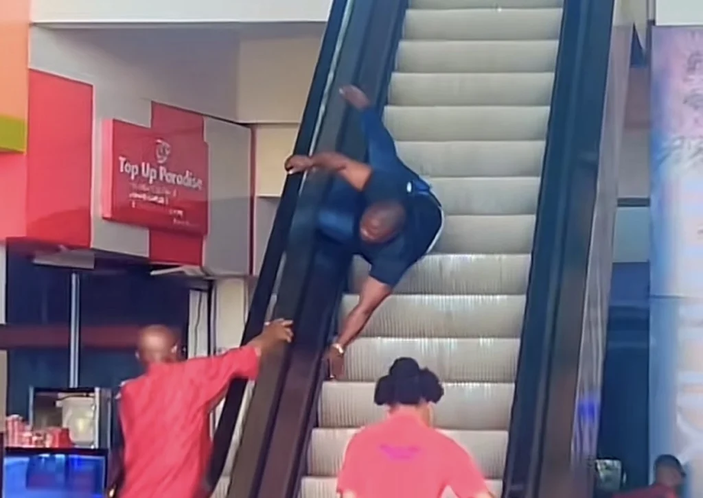 “No be head of the family dey ground so” — Reactions as man gets stuck on escalator 
