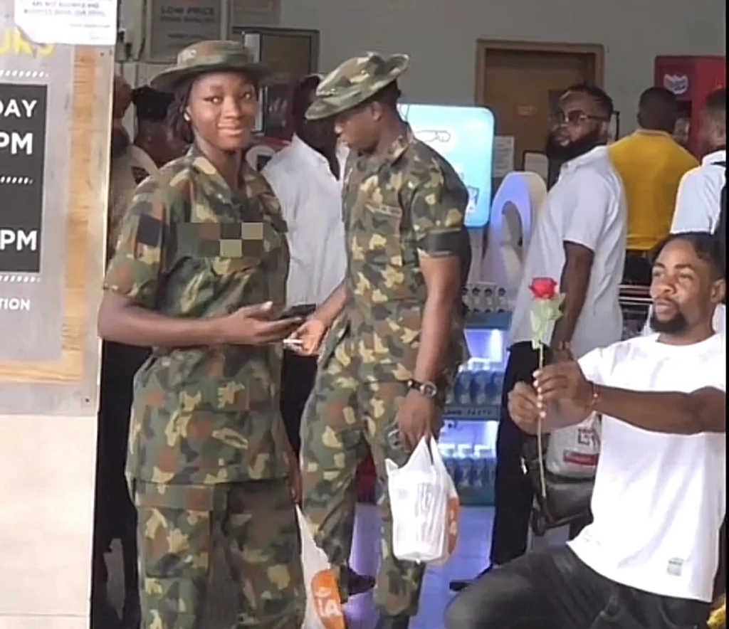 Adorable moment prankster presents soldier with flower and money in public mall