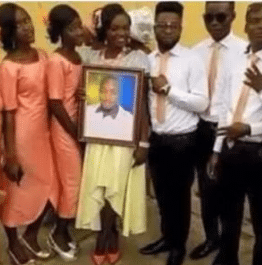 Lady causes stir as she marries photo of lover who claimed to be too busy for wedding