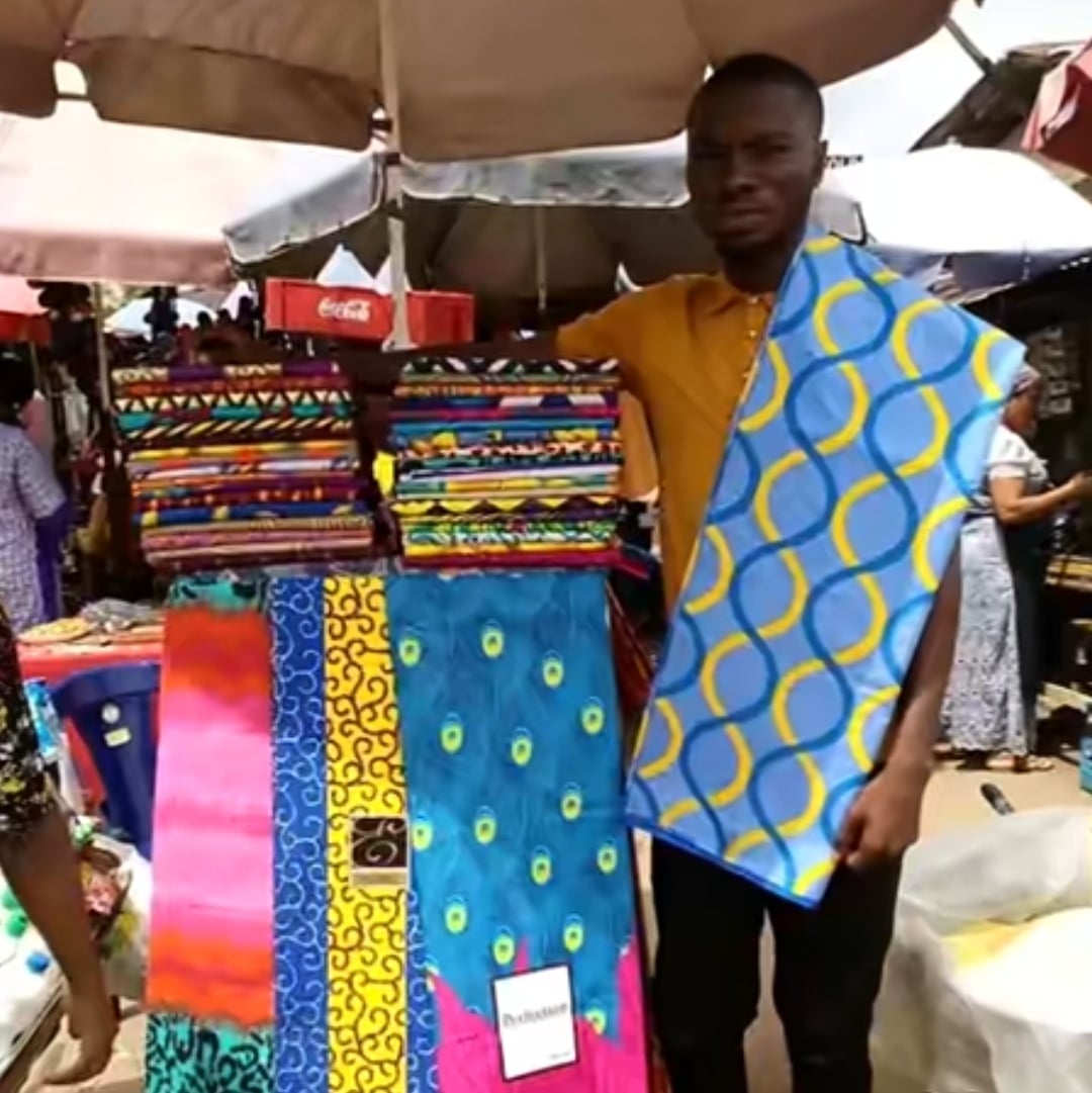 Nigerian man goes from hawking fabrics on wheelbarrow to owning a big shop