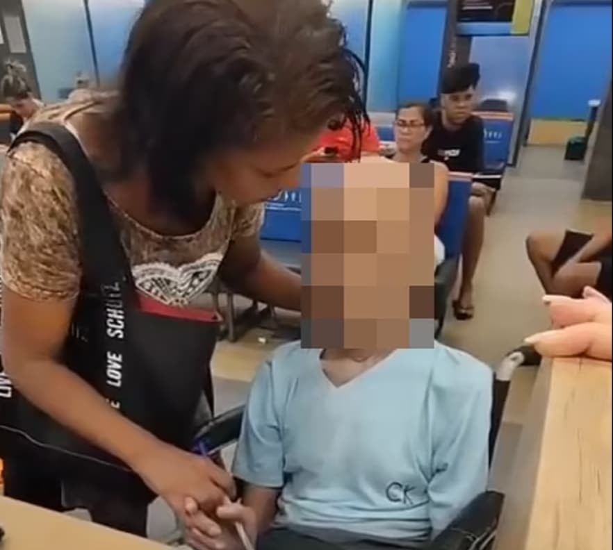 Woman wheels dead man into bank to get him to sign loan papers