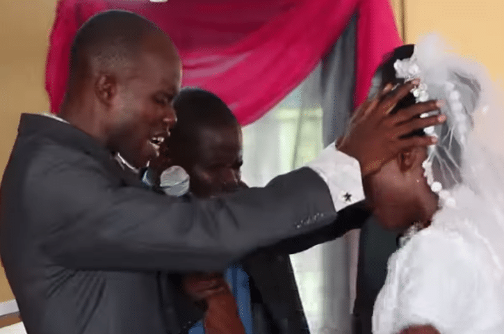 Video of groom fervently praying in tongues over his bride at their wedding goes viral