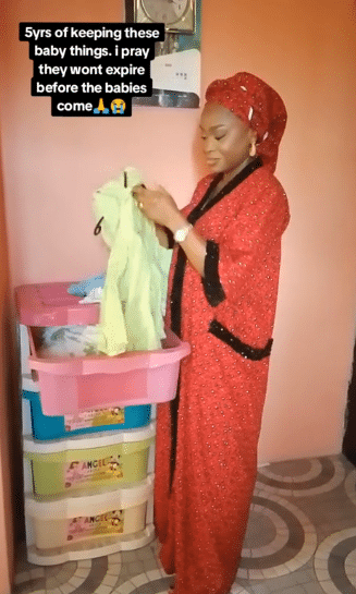 Video of lady looking for fruit of the womb holding onto baby items she bought 5 years ago in hope of pregnancy stirs emotions