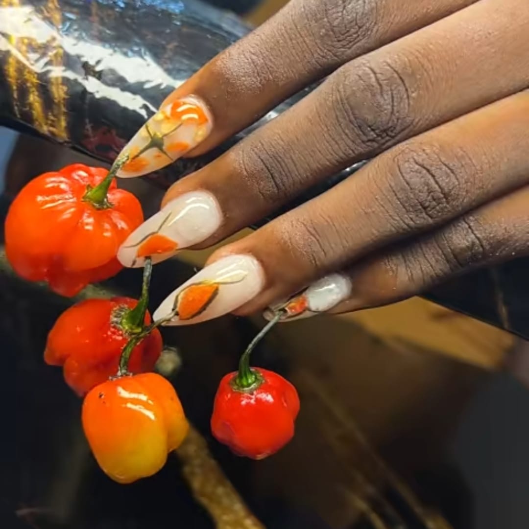 Nigerian lady takes fashion to new heights with pepper and salt nails