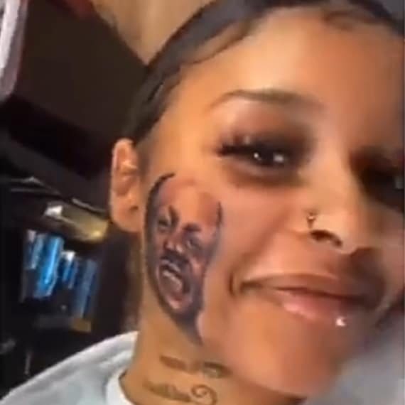 Beautiful lady gets permanent tattoo of boyfriend's face on her face