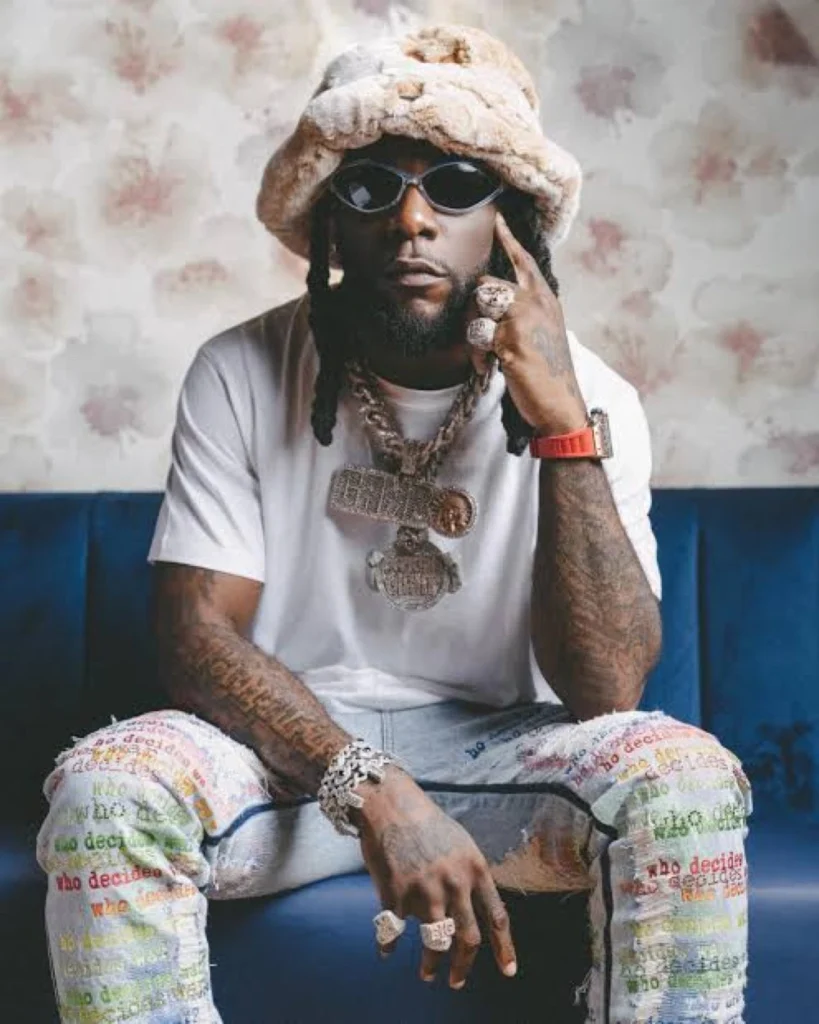 Raised brows over Burna Boy’s special handshake with friend
