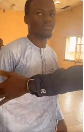 Wahala as student is caught with 'expo' on his native attire 