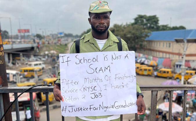 Corps member begs for job on Oshodi Bridge months after NYSC with no employment