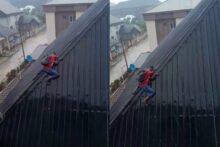Tension as solar panel installer climbs down slippery rooftop during heavy rainfall