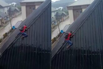 Tension as solar panel installer climbs down slippery rooftop during heavy rainfall