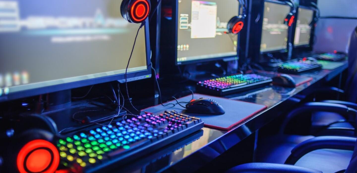 Esports gaming stations with monitors, keyboards and headsets